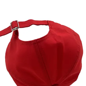 Rear view of red cotton baseball cap featuring an adjustable silver metal buckle strap