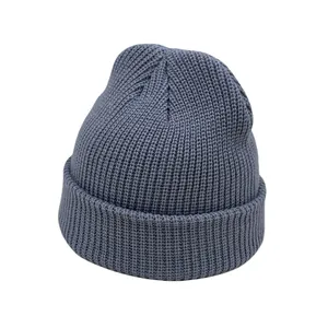 Close-up of deep grey-blue ribbed knit beanie showing thick texture and folded cuff