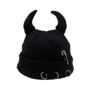 Black knit beanie with devil horns featuring punk metal rings and pin decorations