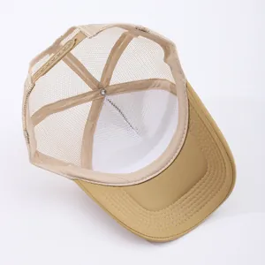 Detail of adjustable plastic snapback closure and breathable mesh on khaki trucker hat