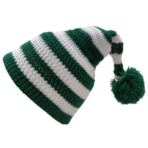 Close-up of green and white striped knit Christmas hat with soft pompom detail