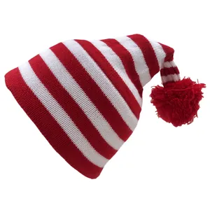 Close-up of red and white striped knit Christmas hat with a fluffy pom-pom detail