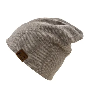 Close-up of the F&S leather patch detail on the textured slouchy knitted beanie hat