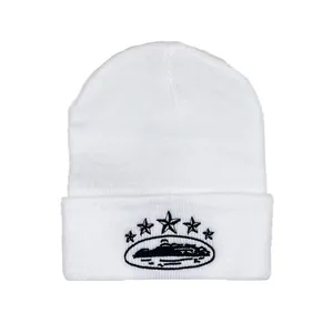 Detail of white beanie embroidery featuring five black stars and a scenic silhouette