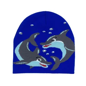 Detail of blue knit beanie featuring intricate dolphin jacquard pattern and bubble accents
