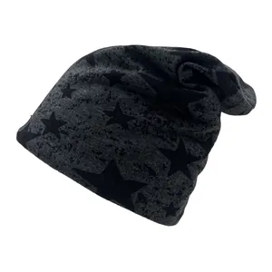 Detail view of the soft knitted fabric texture and black star print on charcoal beanie