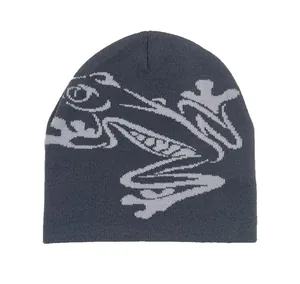 Detailed view of the soft knitted texture and grey frog jacquard pattern on the beanie