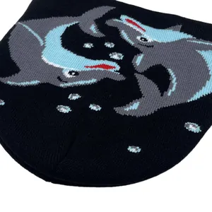 Close-up of dolphin jacquard knit pattern on a black street style winter beanie