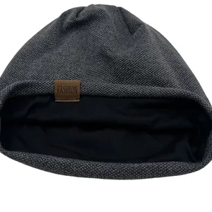 Unisex dark grey knitted beanie hat with black lining and brown leather Fashion label