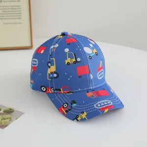 Detail of blue kids baseball cap featuring colorful cartoon construction vehicle prints
