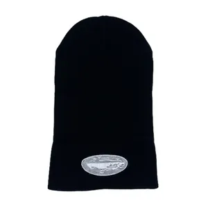 Close-up of the Alcatraz embroidery patch and knit texture on a black beanie
