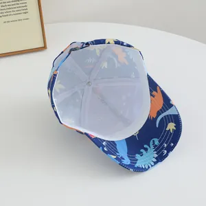 Kids navy baseball cap with dinosaur prints and breathable white mesh lining