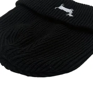 Classic black ribbed knit beanie featuring a white dachshund dog embroidery on the cuff