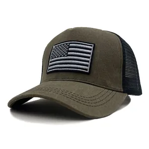 Close-up of olive green tactical trucker hat with USA flag patch and mesh back