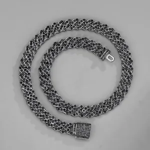 Close-up of black iced-out Cuban link chain with encrusted rhinestones and box clasp