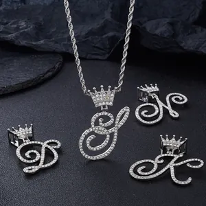 Macro detail of silver hip hop pendants with micro-paved zircons and crown motifs