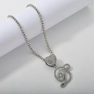 Detail shot of iced out silver letter D pendant on heart link and tennis chain necklace