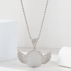 Macro shot of silver hip hop wing pendant with cubic zirconia and rope chain detail