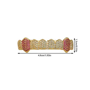 Macro shot of 10-tooth gold plated hip hop grillz with red and white cubic zirconia stones
