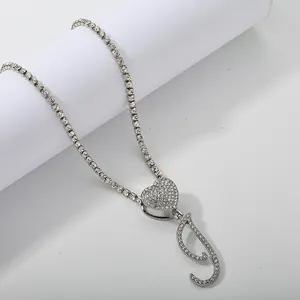Silver tennis chain with heart clasp and crystal-encrusted letter J pendant detail