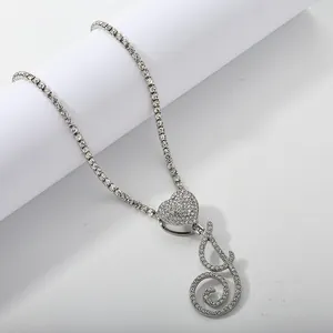 Close-up of hip-hop tennis chain featuring heart pendant and cursive crystal letter