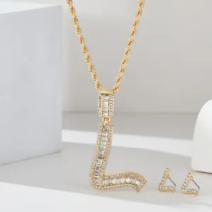 Dettaglio del set di gioielli con collana e orecchini con ciondolo a lettera L lusso