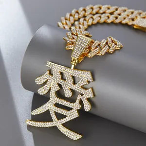 Macro shot of gold-plated hip hop necklace with iced-out Chinese character Love pendant