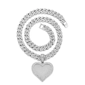 Close-up of silver-tone cuban link necklace with iced out heart pendant and pave rhinestones