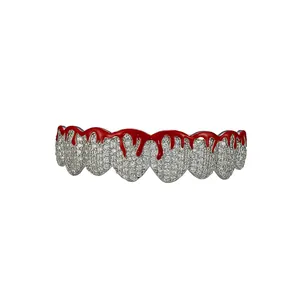 Close-up of hip hop silver grillz featuring iced out crystals and red dripping blood effect