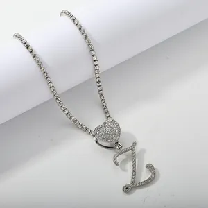Detail of silver tennis chain with iced out heart and letter Z crystal pendants