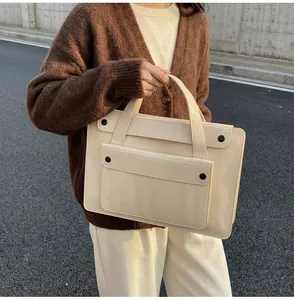 Close-up of beige waterproof business tote bag with dual handles and large front pocket