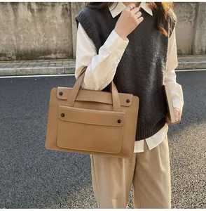 British style khaki laptop briefcase carried by a model against a street background