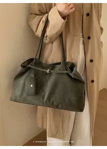 Deep green retro tote bag side view showing large capacity and decorative pouch on shoulder