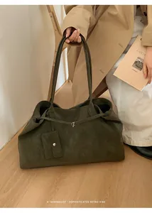 Deep green suede tote bag with long shoulder straps and matching card holder attachment
