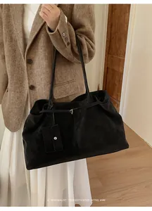 Detail of a large black vintage tote bag with a matching detachable square coin purse