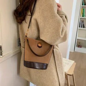 Retro faux suede brown bucket bag for women featuring a stylish leather patchwork design