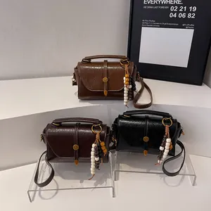 Three vintage Boston bags in brown, coffee, and black with beaded fringe charms