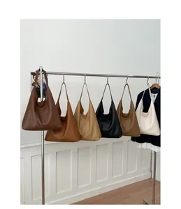 Detailed macro view showing six colors of large capacity hobo tote bags on a display rack