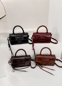 Detail view of four square crossbody bags in black, burgundy, dark coffee, and brown colors