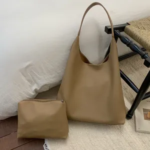 Detail of camel pebbled leather hobo tote bag set with a matching zipper pouch