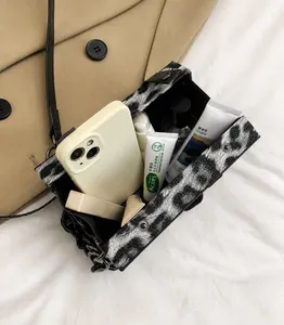 Leopard print crossbody bag interior showing spacious storage for phone and cosmetics