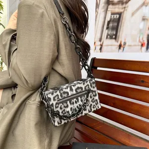 Modern black and white leopard print box bag with chunky chain strap on khaki blazer