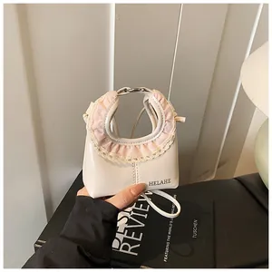 Close-up of cream white mini tote bag featuring pink checkered lace trim on handle