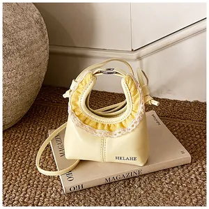 Detail of yellow tote bag featuring checkered ruffle trim and lace edges on magazine