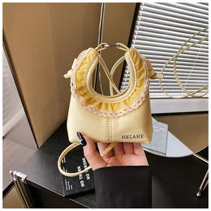 Detail showing lace trim, yellow plaid fabric, and HELAHE logo on the small shoulder bag