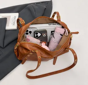 Top view of brown Boston bag interior showing capacity for umbrella and phones