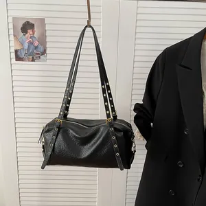 Classic black leather Boston shoulder bag with vintage gold eyelets and long straps