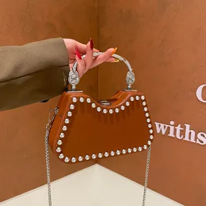 Chic brown arc shoulder bag with silver studs and wavy metallic handle detail