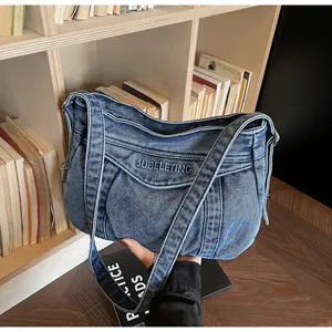 Vue détaillée du sac cabas en denim bleu avec broderie SUBELETING sur le tissu
