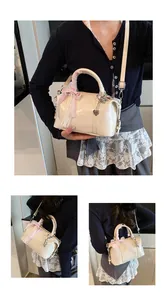 Detail of beige pillow bag with pink plaid bow and MARJOR & GORDOW embossing